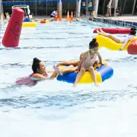SPLASH! fun at Coastlands Aquatic Centre - a mother having fun with her two children in an inflatable ring. thumbnail