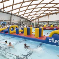 SoundSplash event at Coastlands Aquatic Centre - Kids swimming in the pool beside giant inflatable obstacle course thumbnail