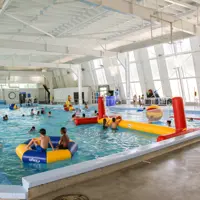 SPLASH! at Ōtaki pool | Kids swimming in the pool with an inflatable volleyball net, inflatable rings, ride-ons and giant inflatable balls. thumbnail