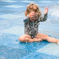 Toddler enjoying the water spray at one of our splashpads thumbnail