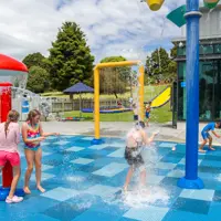 Summer fun at Ōtaki Pool splashpad with the slippery slope in the background. thumbnail