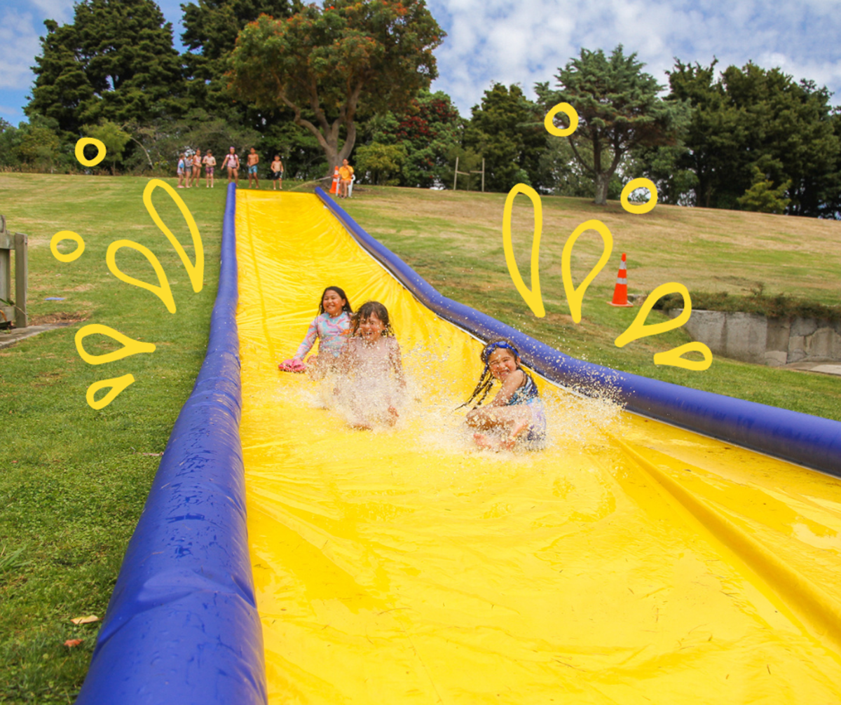 Kids enjoying the water slide, Te Mania Auheke (the slippery slope) at Ōtaki Pool
